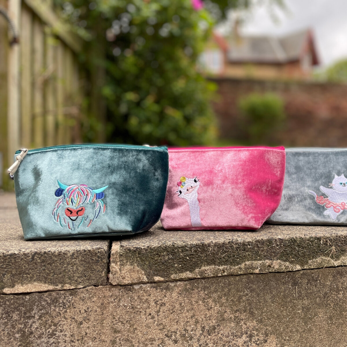 Silk Velvet Makeup Bag in luxurious fabric with embroidered designs, featuring a splashproof lining