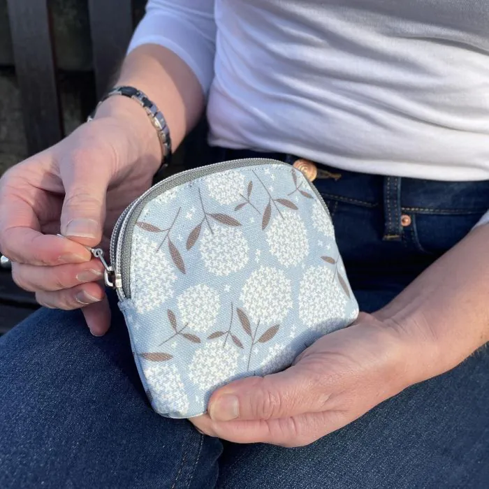 Oil Cloth Purse – A compact coin purse with credit card slots and a durable oilcloth finish, easy to clean.